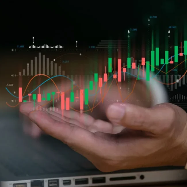 Hands next to investment charts