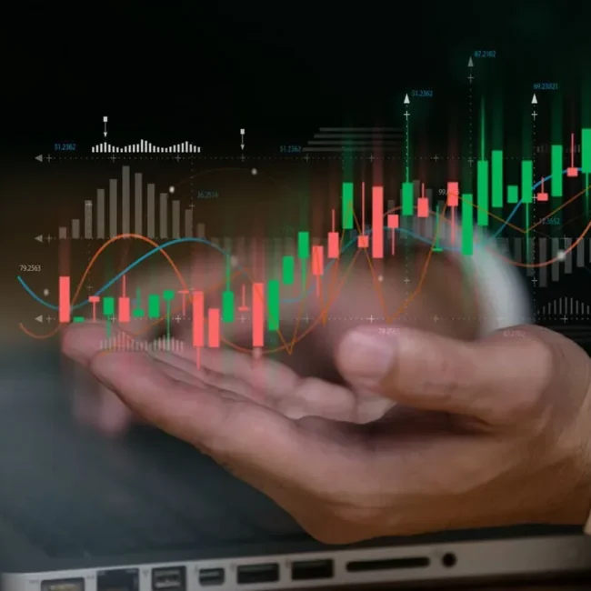 Hands next to investment charts